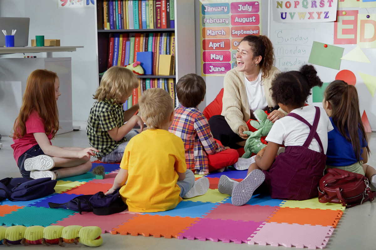 Teacher in kindergarten classroom with students