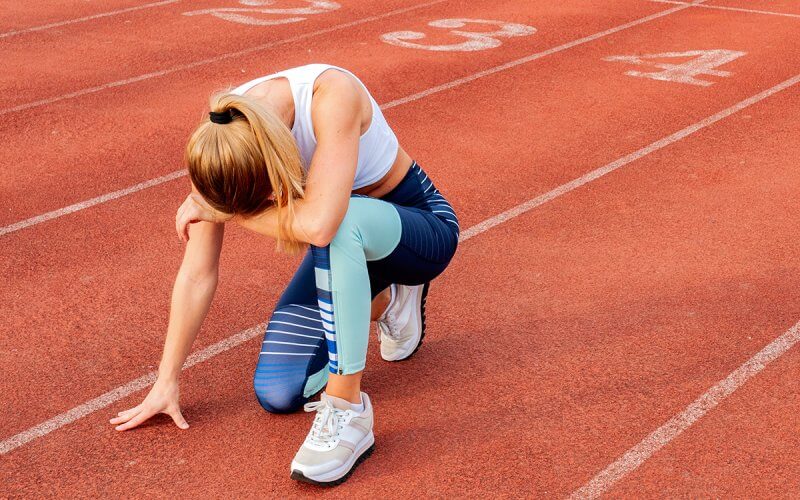 A runner rests at the end of a run.