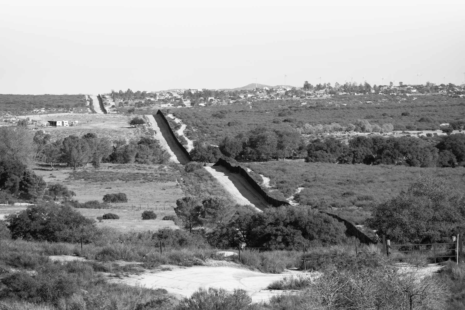 Panoramic view of existing border fence in the desert.